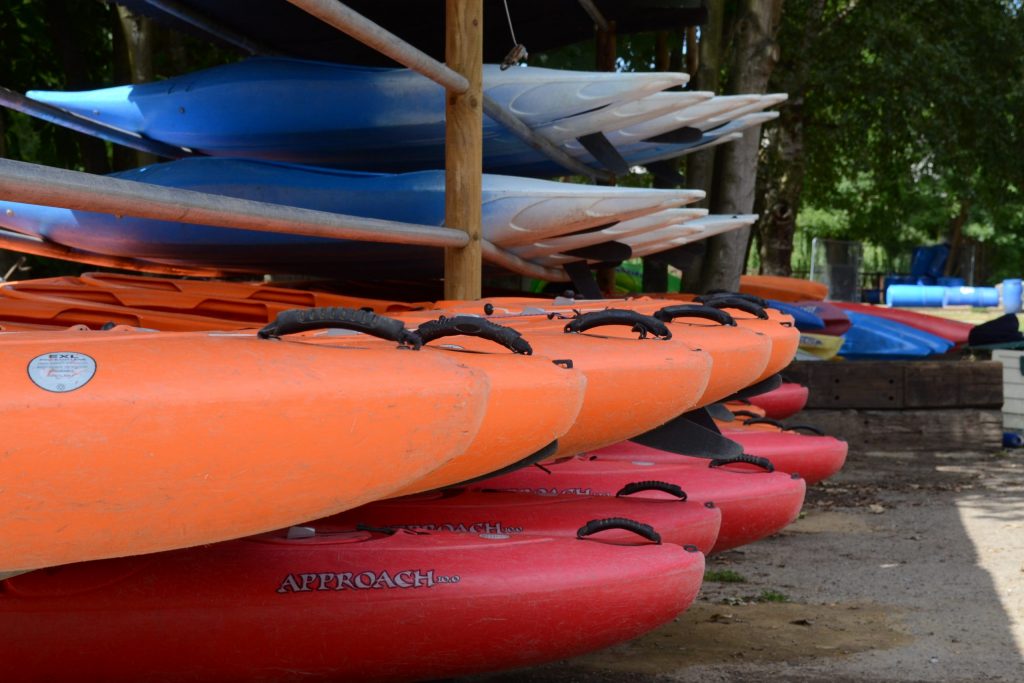 Colourful canoes on racks